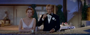 Movie still from “Daddy Long Legs” (1955), directed by Jean Negulesco – A man in a tuxedo drinking a cup of coffee; Medium shot, Low angle