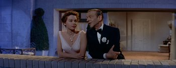 Movie still from “Daddy Long Legs” (1955), directed by Jean Negulesco – An older man and a younger woman sitting at a bar; Medium shot, Low angle