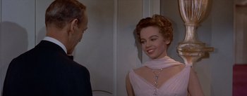 Movie still from “Daddy Long Legs” (1955), directed by Jean Negulesco – A man and a woman in a room with a door; Close Up shot, Over the shoulder angle