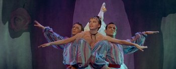 Movie still from “Daddy Long Legs” (1955), directed by Jean Negulesco – A group of men and a woman performing on a stage; Medium shot, Low angle