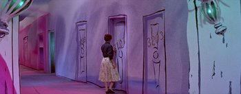 Movie still from “Daddy Long Legs” (1955), directed by Jean Negulesco – A woman standing in front of a purple wall; Wide shot, High angle