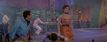 Movie still from “Daddy Long Legs” (1955), directed by Jean Negulesco – A man laying on the ground next to a woman; Medium shot, Low angle