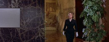 Movie still from “Daddy Long Legs” (1955), directed by Jean Negulesco – A woman in a black dress walking in a room; Wide shot, Low angle