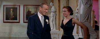 Movie still from “Daddy Long Legs” (1955), directed by Jean Negulesco – A man and a woman standing next to each other; Medium shot, Over the shoulder angle