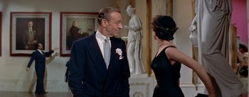 Movie still from “Daddy Long Legs” (1955), directed by Jean Negulesco – A man and a woman talking in front of a statue; Medium shot, Over the shoulder angle