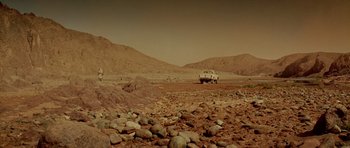Movie still from “The Hills Have Eyes” (2006), directed by Alexandre Aja – A car parked on top of a dirt field; Extreme Wide shot, High angle