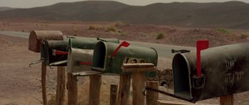 Movie still from “The Hills Have Eyes” (2006), directed by Alexandre Aja – Two mailboxes on the side of a road; Wide shot, Low angle
