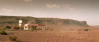Movie still from “The Hills Have Eyes” (2006), directed by Alexandre Aja – An abandoned gas station sits in the middle of the desert; Extreme Wide shot, Low angle