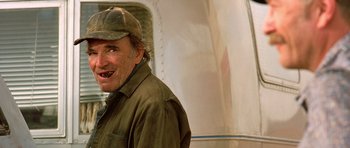 Movie still from “The Hills Have Eyes” (2006), directed by Alexandre Aja – An older man wearing a hat and smiling; Close Up shot, Low angle