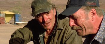 Movie still from “The Hills Have Eyes” (2006), directed by Alexandre Aja – A man wearing a hat and a jacket; Close Up shot, Over the shoulder angle