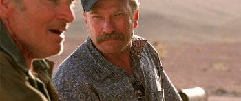 Movie still from “The Hills Have Eyes” (2006), directed by Alexandre Aja – A person wearing a hat; Close Up shot, Over the shoulder angle