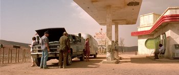 Movie still from “The Hills Have Eyes” (2006), directed by Alexandre Aja – Two men and a truck at a gas station; Wide shot, Over the shoulder angle