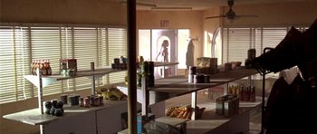 Movie still from “The Hills Have Eyes” (2006), directed by Alexandre Aja – A kitchen with a lot of food on the counter; Extreme Wide shot, High angle