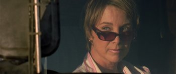Movie still from “The Hills Have Eyes” (2006), directed by Alexandre Aja – A person wearing sunglasses; Close Up shot, Over the shoulder angle