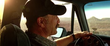 Movie still from “The Hills Have Eyes” (2006), directed by Alexandre Aja – An older man wearing a hat driving a truck; Close Up shot, Low angle