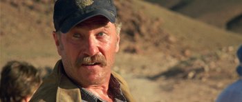 Movie still from “The Hills Have Eyes” (2006), directed by Alexandre Aja – A person wearing a hat; Close Up shot, Over the shoulder angle