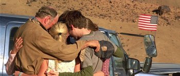 Movie still from “The Hills Have Eyes” (2006), directed by Alexandre Aja – A group of young people hugging in front of a car; Medium shot, High angle