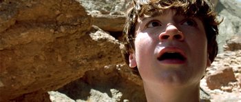 Movie still from “The Hills Have Eyes” (2006), directed by Alexandre Aja – A young boy looking up into the sky; Extreme Close Up shot, Low angle