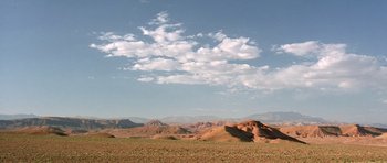 Movie still from “The Hills Have Eyes” (2006), directed by Alexandre Aja – A desert landscape with mountains in the background; Extreme Wide shot, Low angle