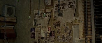 Movie still from “The Hills Have Eyes” (2006), directed by Alexandre Aja – A wall covered with newspapers and news clippings; Wide shot, High angle