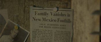 Movie still from “The Hills Have Eyes” (2006), directed by Alexandre Aja – An old newspaper with a clipping of an article; Extreme Close Up shot, High angle