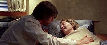 Movie still from “The Hills Have Eyes” (2006), directed by Alexandre Aja – A man and a woman laying on a bed; Medium shot, Over the shoulder angle