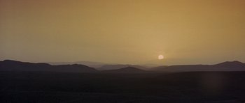 Movie still from “The Hills Have Eyes” (2006), directed by Alexandre Aja – The sun is setting over a large expanse of land; Extreme Wide shot, Low angle