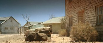 Movie still from “The Hills Have Eyes” (2006), directed by Alexandre Aja – An old car parked in front of an abandoned house; Wide shot, Low angle