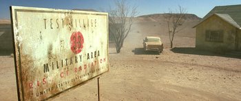 Movie still from “The Hills Have Eyes” (2006), directed by Alexandre Aja – An image of an old car in the middle of a desert; Extreme Wide shot, High angle