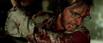 Movie still from “The Hills Have Eyes” (2006), directed by Alexandre Aja – A person with blood on his face; Close Up shot, Over the shoulder angle