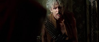 Movie still from “The Hills Have Eyes” (2006), directed by Alexandre Aja – An old man with a bunch of bullets around his neck; Close Up shot, Over the shoulder angle