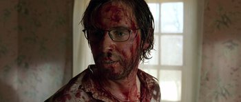 Movie still from “The Hills Have Eyes” (2006), directed by Alexandre Aja – A person with blood all over his face; Close Up shot, Over the shoulder angle