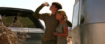 Movie still from “The Hills Have Eyes” (2006), directed by Alexandre Aja – A man and a woman drinking water from a water bottle; Medium shot, Low angle