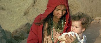 Movie still from “The Hills Have Eyes” (2006), directed by Alexandre Aja – A native american woman holding a baby in her arms; Close Up shot, High angle