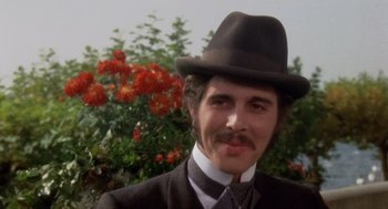 Movie still from “Daisy Miller” (1974), directed by Peter Bogdanovich – A person wearing a suit and a hat; Close Up shot, Low angle