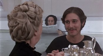 Movie still from “Daisy Miller” (1974), directed by Peter Bogdanovich – A woman and a man are sitting in front of a mirror; Close Up shot, Over the shoulder angle