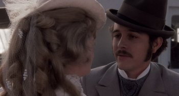 Movie still from “Daisy Miller” (1974), directed by Peter Bogdanovich – A man and a woman wearing hats and a suit; Close Up shot, Over the shoulder angle