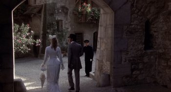 Movie still from “Daisy Miller” (1974), directed by Peter Bogdanovich – A group of people walking around a courtyard; Wide shot, Over the shoulder angle