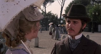 Movie still from “Daisy Miller” (1974), directed by Peter Bogdanovich – A man and a woman wearing hats and holding umbrellas; Close Up shot, Low angle
