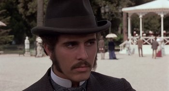 Movie still from “Daisy Miller” (1974), directed by Peter Bogdanovich – A person wearing a hat and a suit; Close Up shot, Low angle