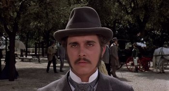 Movie still from “Daisy Miller” (1974), directed by Peter Bogdanovich – A man with a mustache wearing a suit and a hat; Close Up shot, Low angle