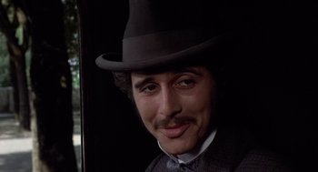 Movie still from “Daisy Miller” (1974), directed by Peter Bogdanovich – A person wearing a suit and a hat; Close Up shot, Low angle