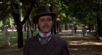 Movie still from “Daisy Miller” (1974), directed by Peter Bogdanovich – A man in a suit and hat standing in a park; Close Up shot, Low angle