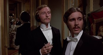 Movie still from “Daisy Miller” (1974), directed by Peter Bogdanovich – Two men in tuxedos holding a glass of wine; Close Up shot, Low angle