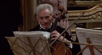 Movie still from “Daisy Miller” (1974), directed by Peter Bogdanovich – An older man in a tuxedo playing the cello; Medium shot, High angle