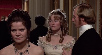 Movie still from “Daisy Miller” (1974), directed by Peter Bogdanovich – Two women and a man standing in front of a wall; Close Up shot, Over the shoulder angle