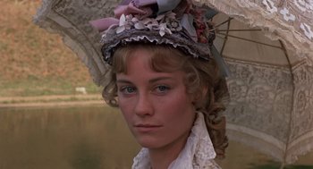 Movie still from “Daisy Miller” (1974), directed by Peter Bogdanovich – A woman with a hat and a parasol in front of a body of water; Close Up shot, Low angle