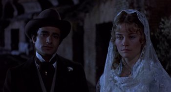 Movie still from “Daisy Miller” (1974), directed by Peter Bogdanovich – A man and a woman standing next to each other in front of a building; Close Up shot, Low angle