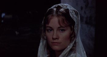 Movie still from “Daisy Miller” (1974), directed by Peter Bogdanovich – A woman wearing a white veil looking at the camera; Close Up shot, High angle