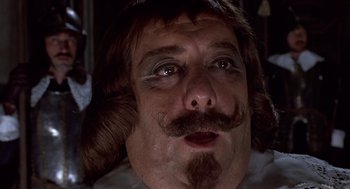 Movie still from “Daisy Miller” (1974), directed by Peter Bogdanovich – A person with a beard and a mustache; Close Up shot, Over the shoulder angle
